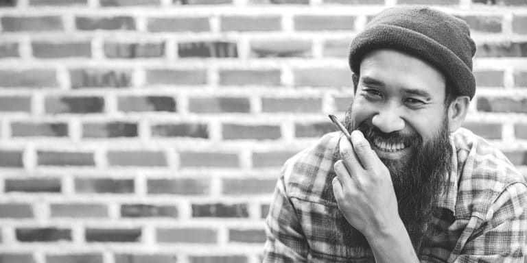 man smiling and smoking 2X1