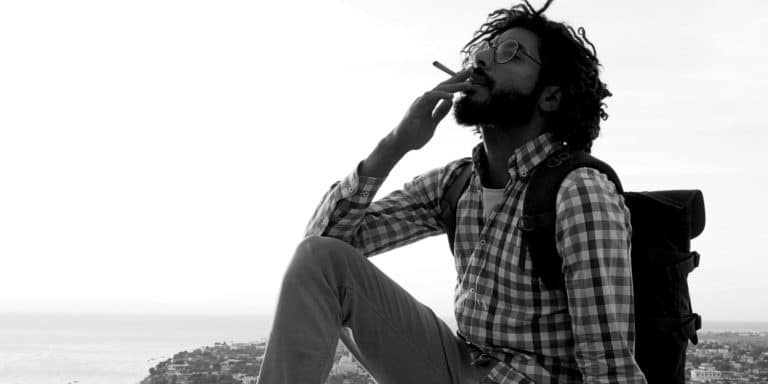 black man smoking on hill