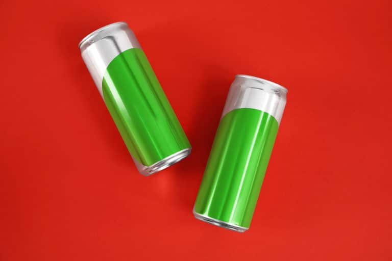 Blank metal cans on color background, flat lay