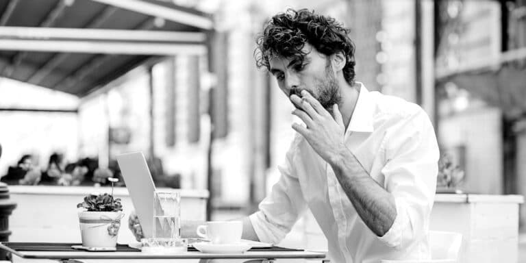 man smoking at table 2X1